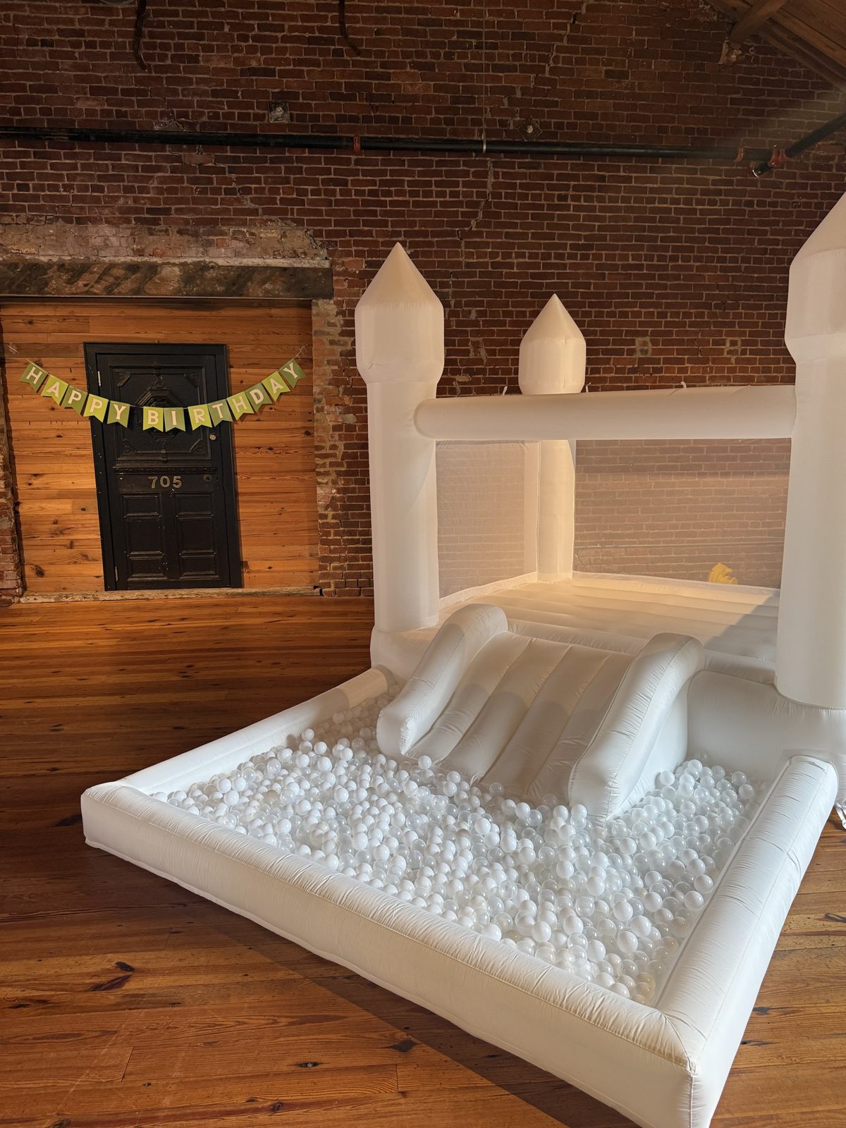 The Hartwell Petite set up indoors with an all-white and clear ball pit